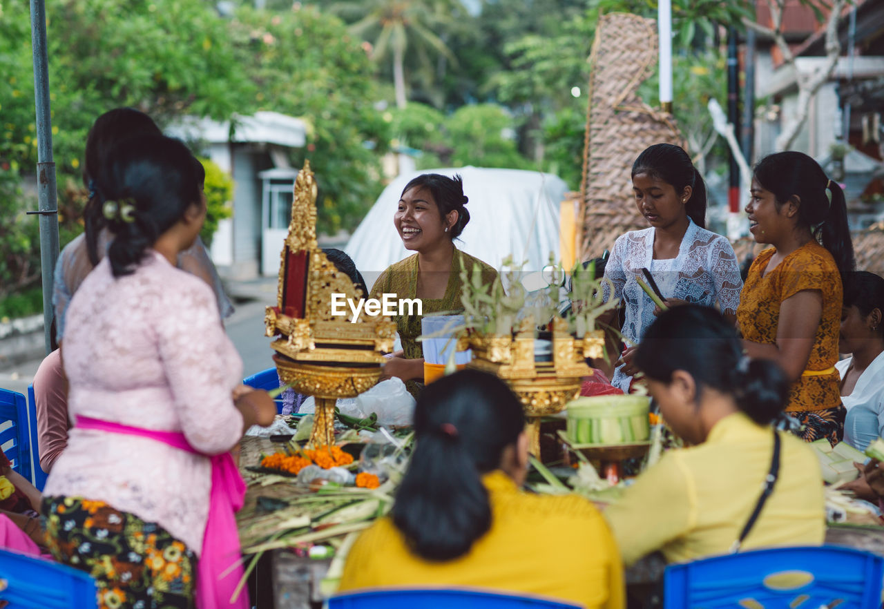 PEOPLE SITTING IN MARKET