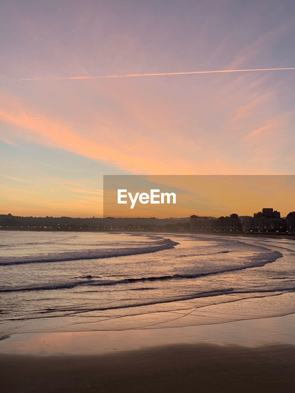 Scenic view of beach against sky during sunset