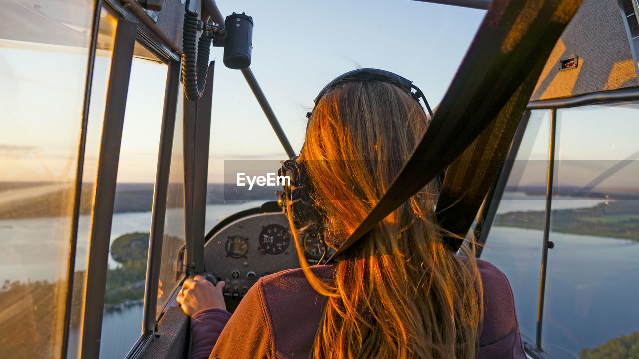 Rear view of woman flying air vehicle