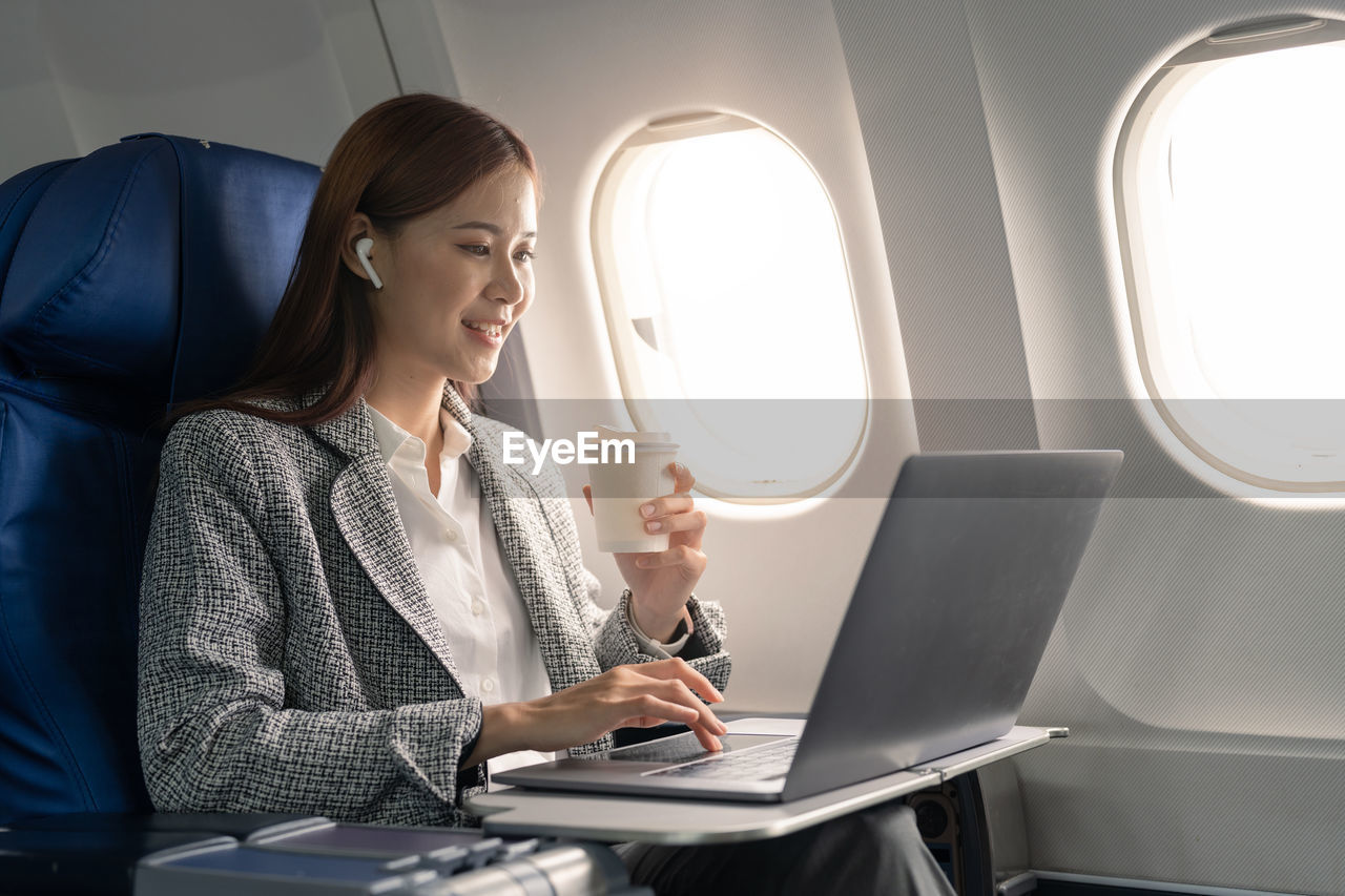 businesswoman using laptop while sitting in car