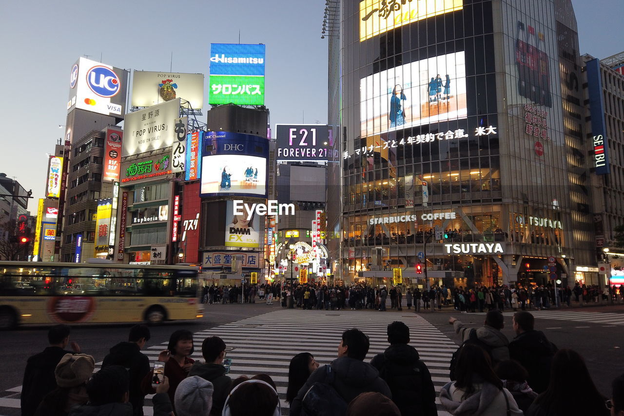 GROUP OF PEOPLE CROSSING CITY STREET