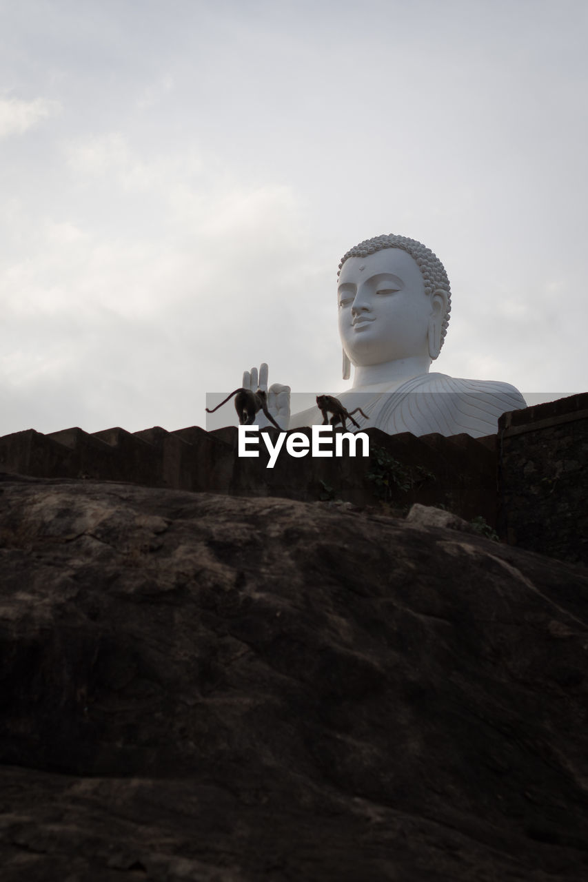 Low angle view of statue against sky