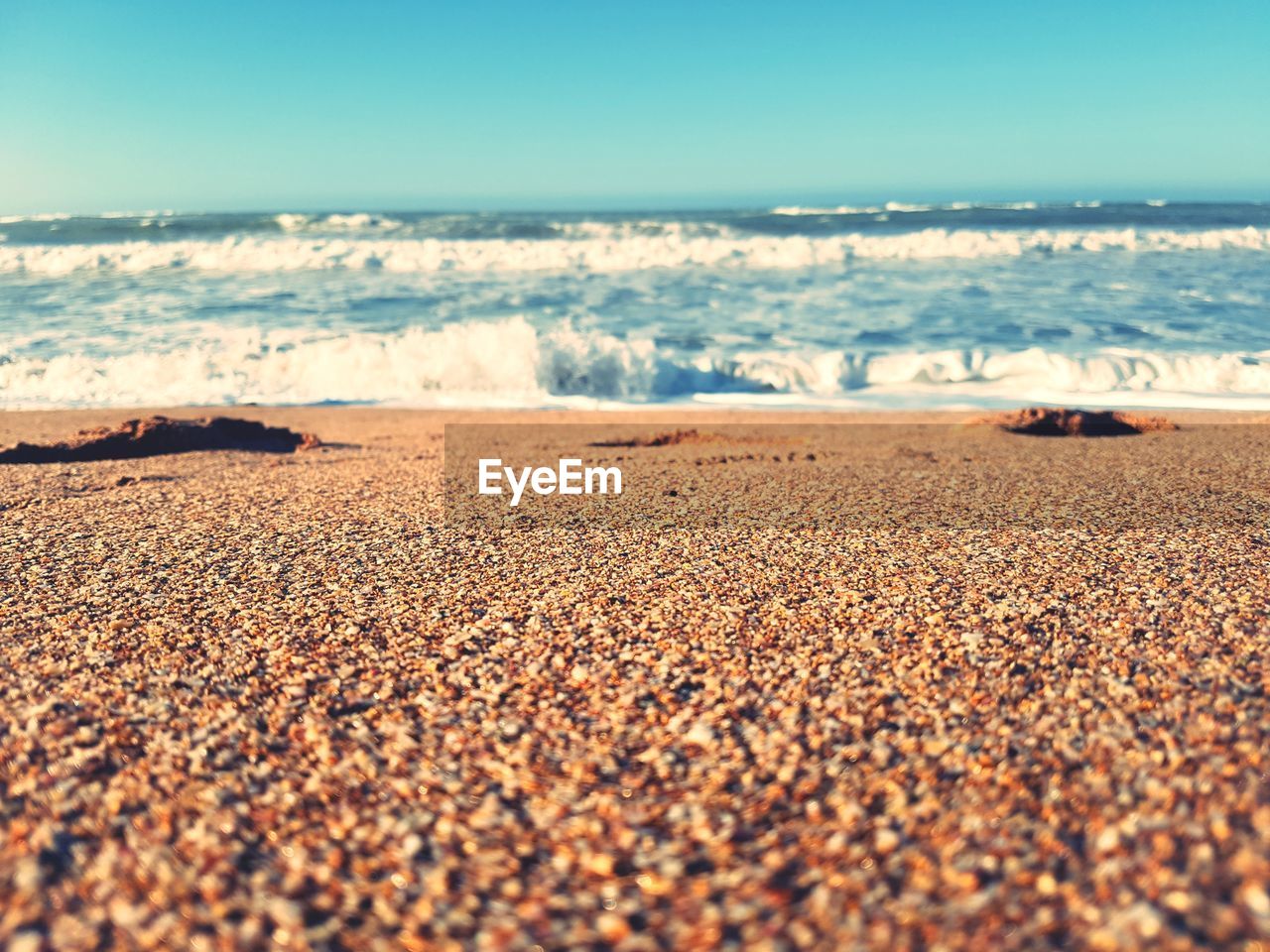 Scenic view of beach against clear sky