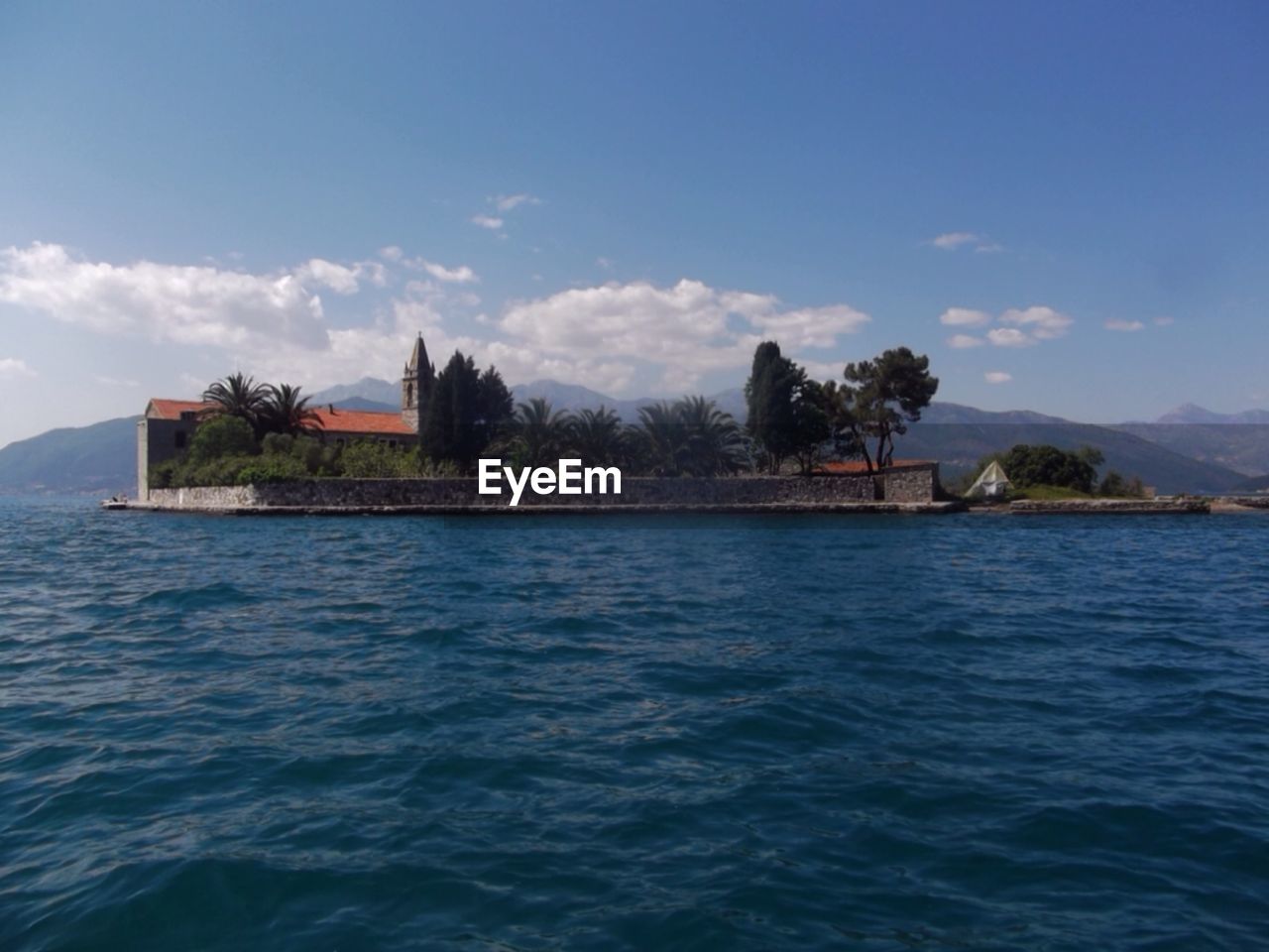 Scenic view of sea and island against sky