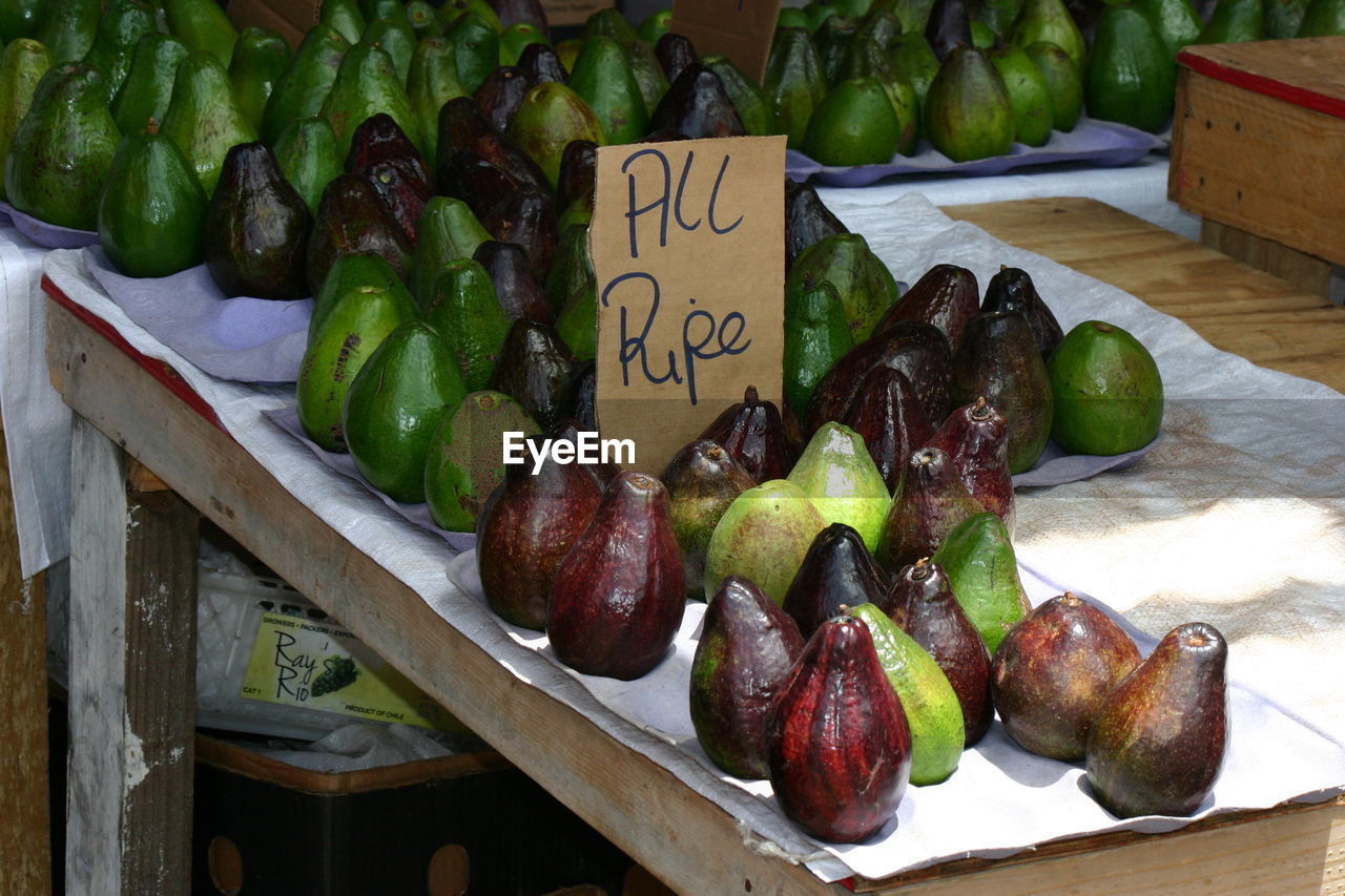 Avocados on table at market for sale