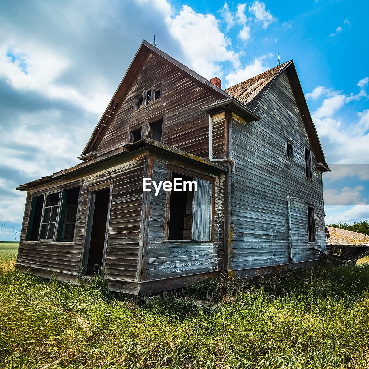 Abandoned farmhouse against blue skies