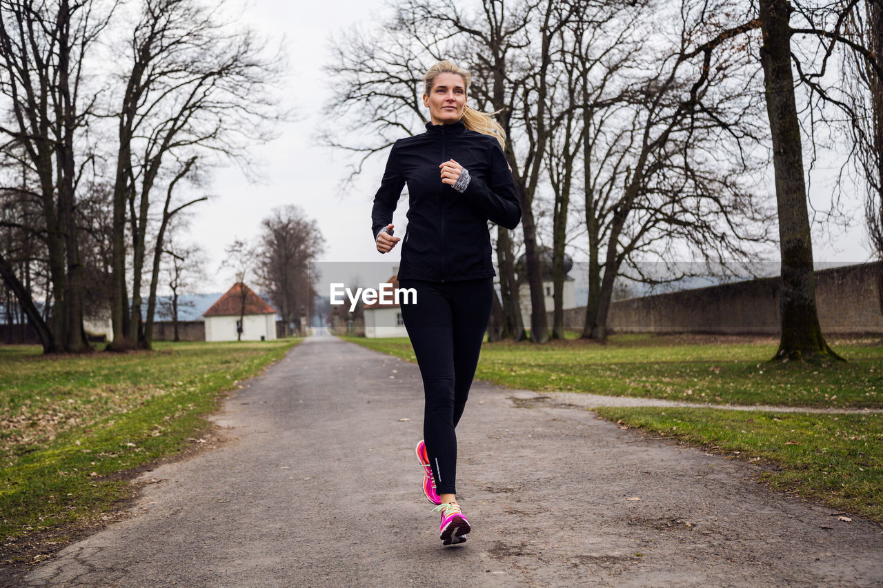 Portrait of young woman running