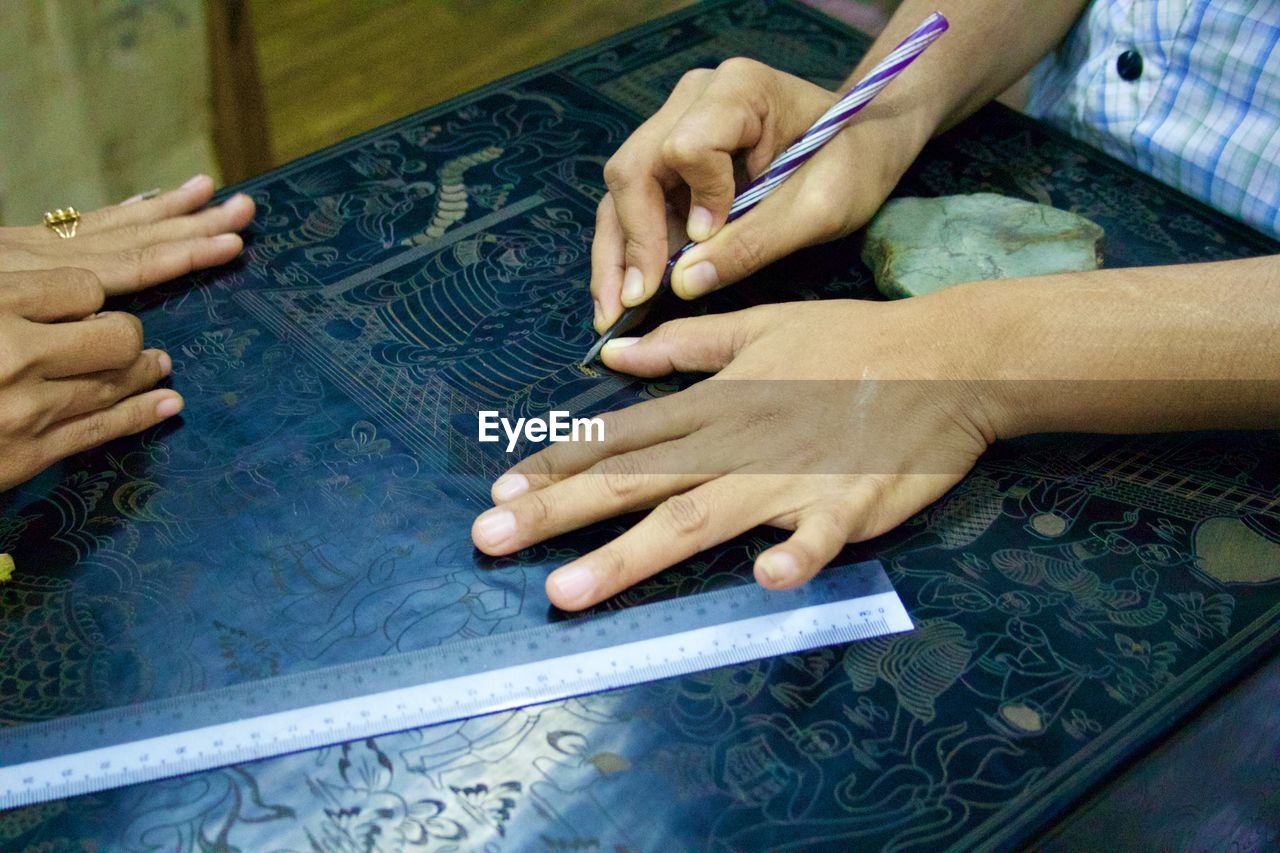 Cropped hands of woman making craft