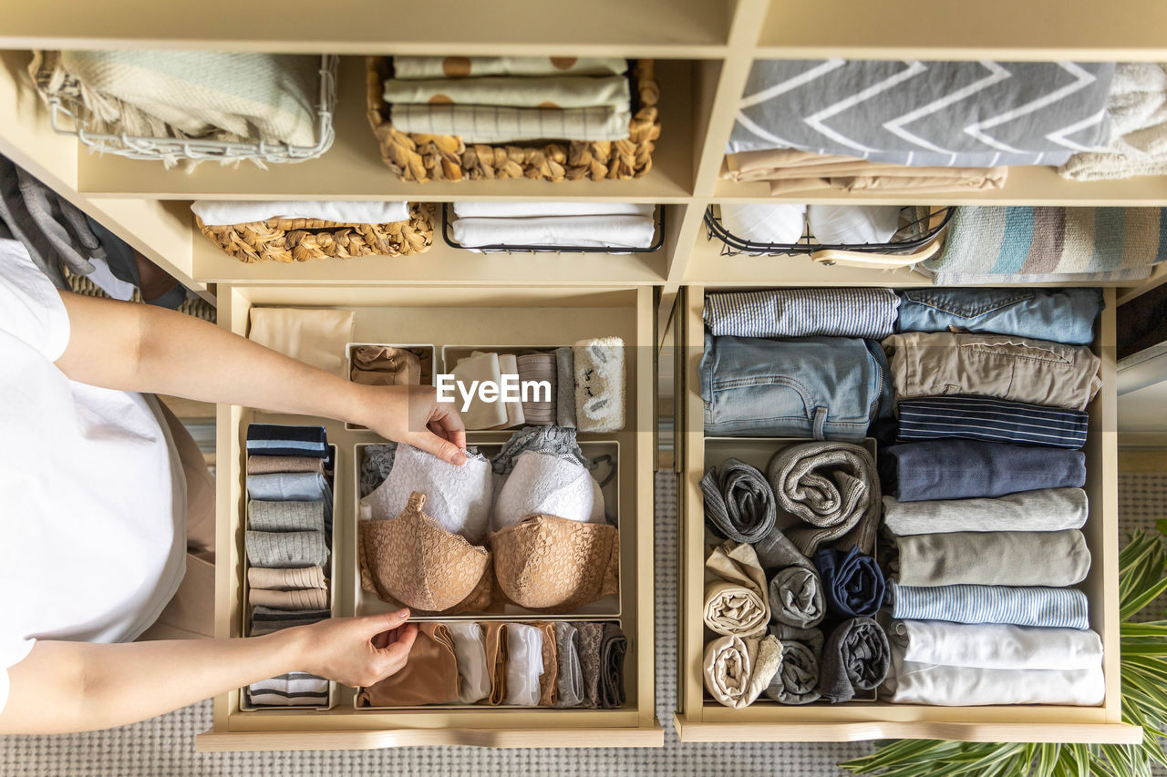 midsection of woman standing in shelf