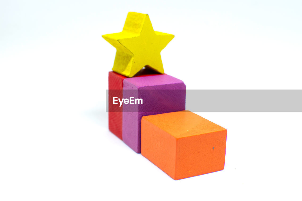 white background, cut out, studio shot, multi colored, indoors, no people, shape, toy, block, toy block, block shape, yellow, cube shape, copy space, red