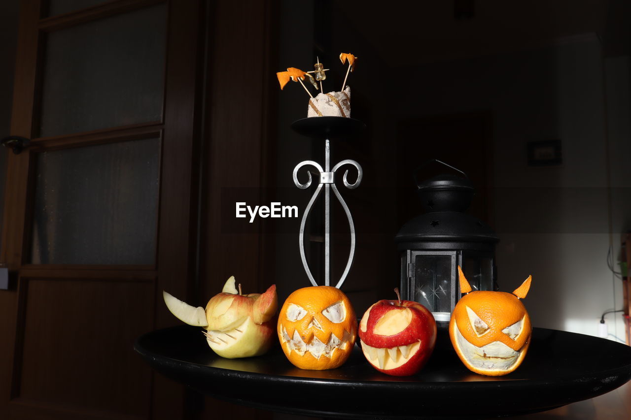 Fruits with anthropomorphic face on table at home