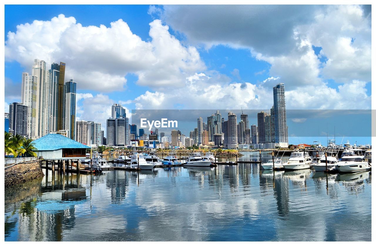 View of harbor against cloudy sky