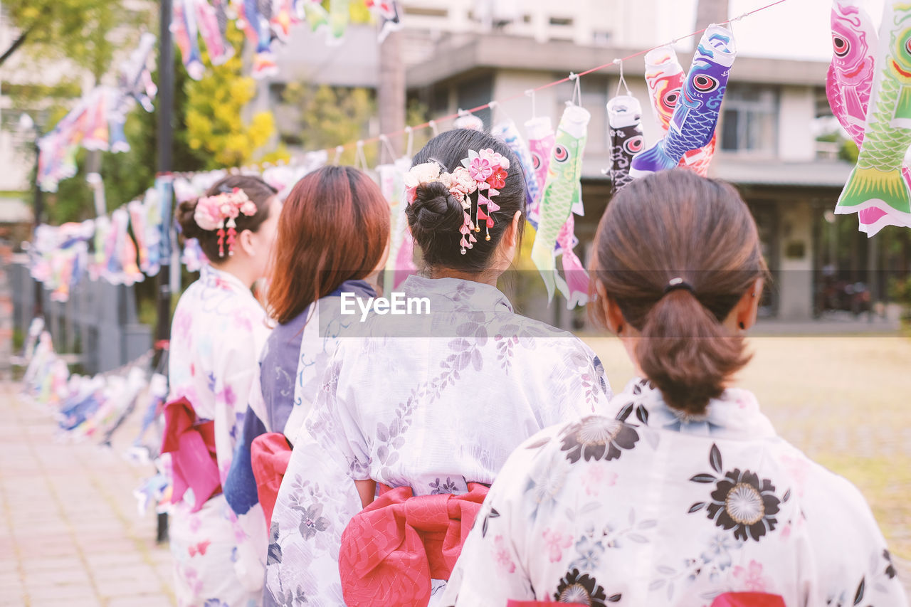 Women wearing kimono while standing on street