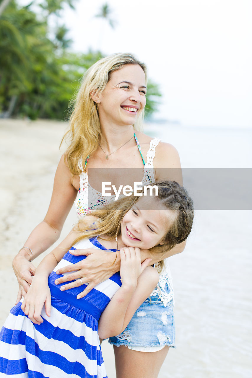 Happy mother and daughter at beach