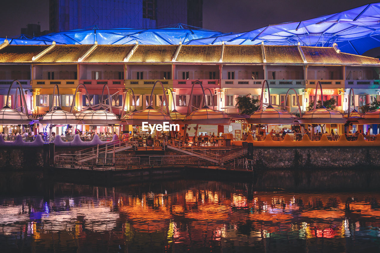 Singapore's clarke quay area at night, riverside restaurant with light reflections in the water