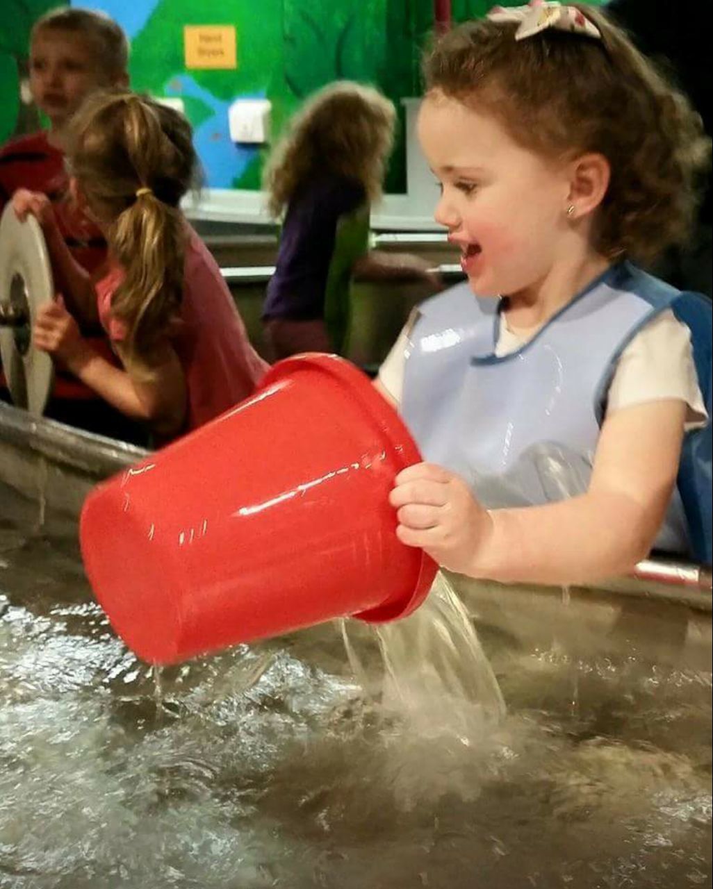 LITTLE GIRL PLAYING WITH ARMS RAISED