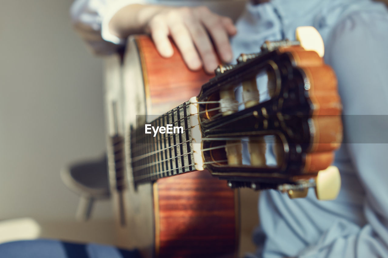 Close-up of man holding guitar