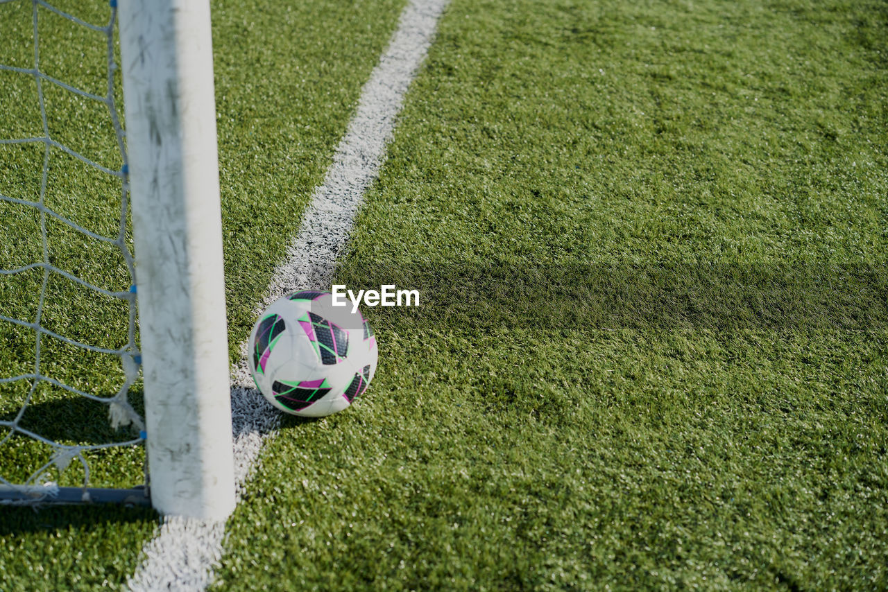 Football soccer goals and ball on clean empty green field