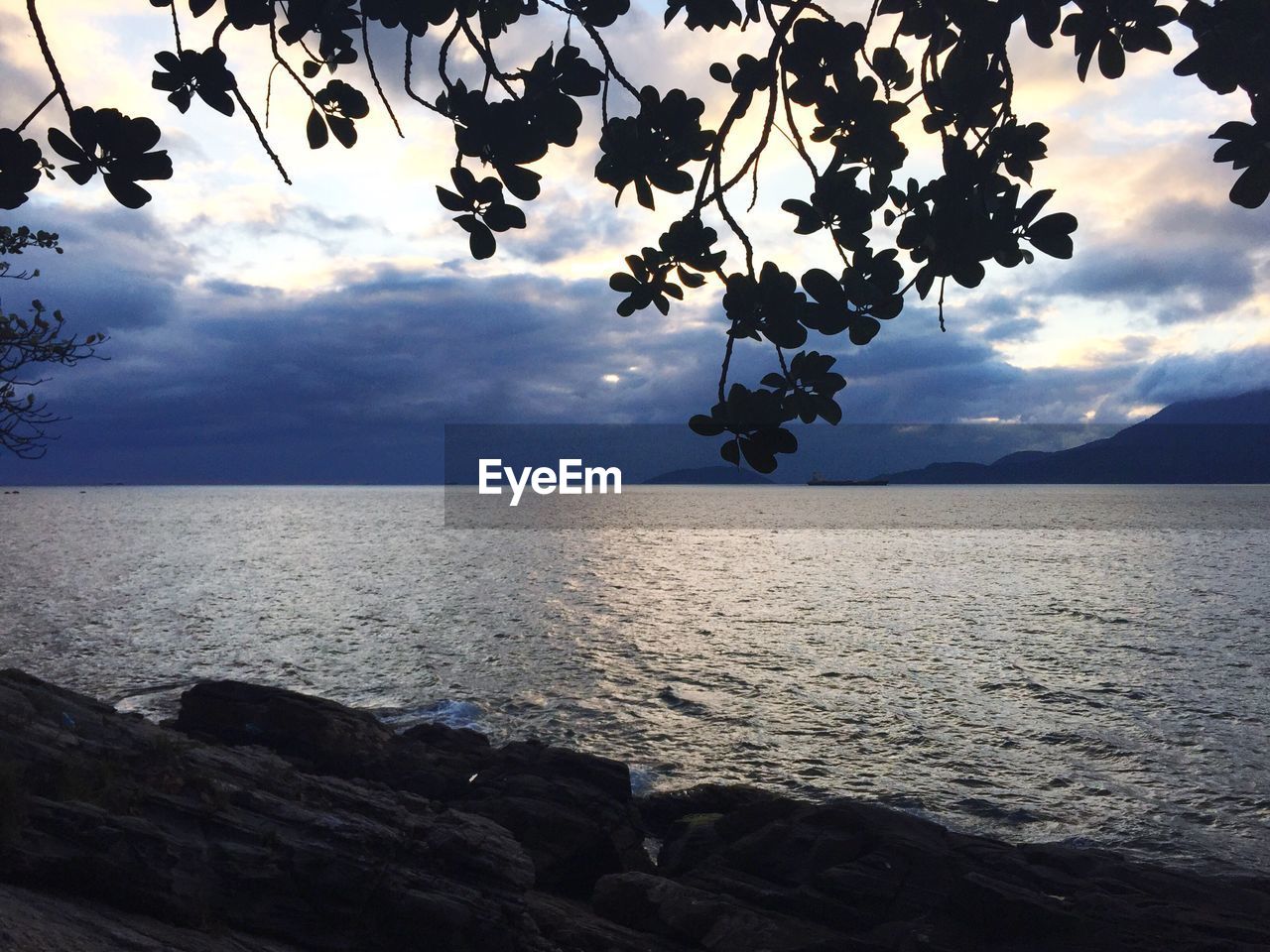 SCENIC VIEW OF BEACH AGAINST SKY DURING SUNSET
