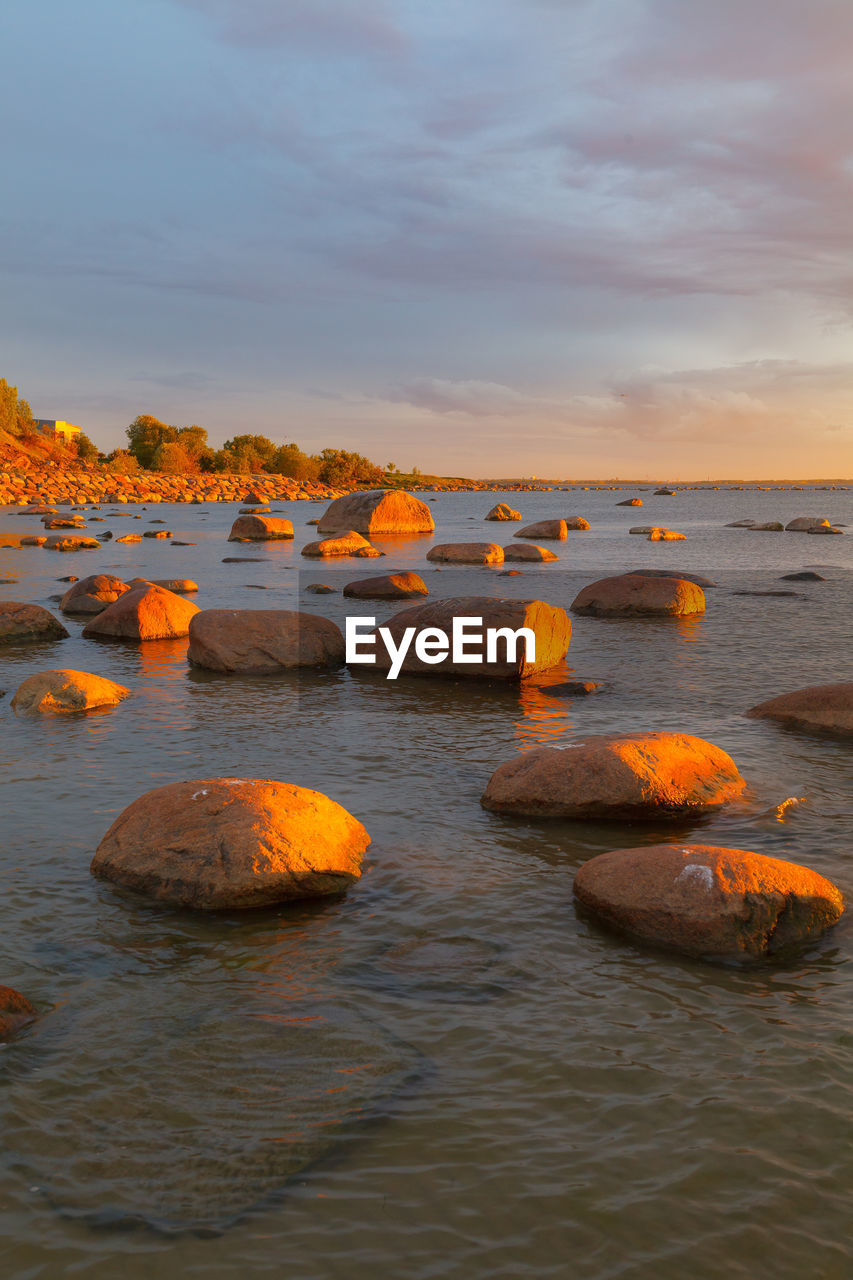 water, sky, sea, shore, reflection, nature, coast, sunset, land, ocean, beauty in nature, scenics - nature, cloud, tranquility, rock, beach, orange color, no people, tranquil scene, outdoors, dusk, body of water, environment, horizon over water, sand, evening, horizon, bay, idyllic, travel, travel destinations, non-urban scene, landscape, wave, seascape, day