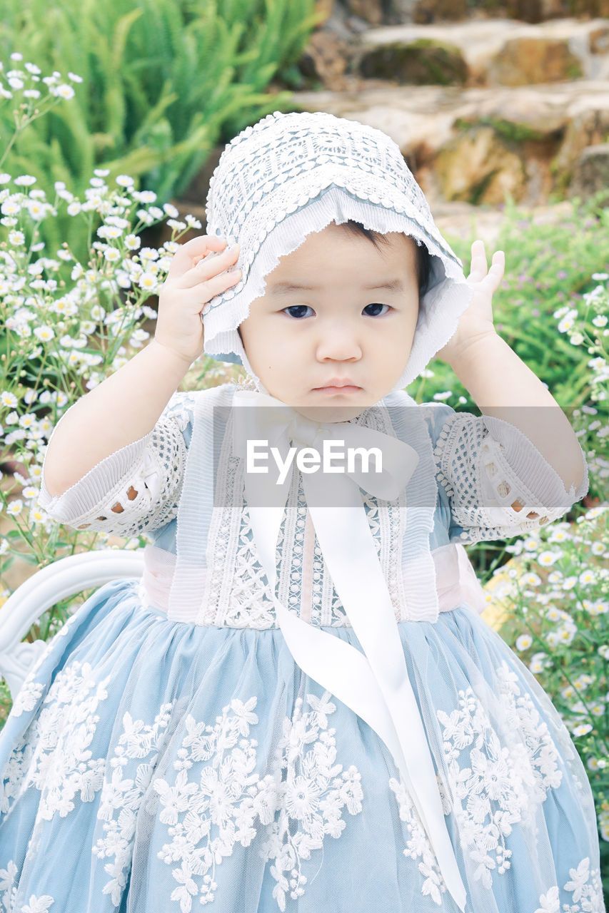 Portrait of baby girl standing on field