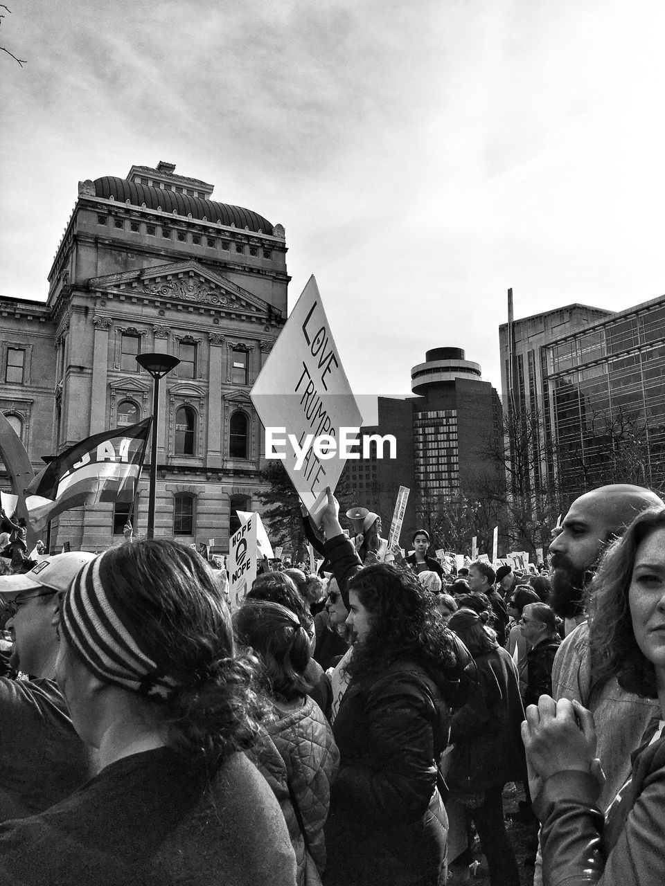 GROUP OF PEOPLE IN FRONT OF BUILDINGS