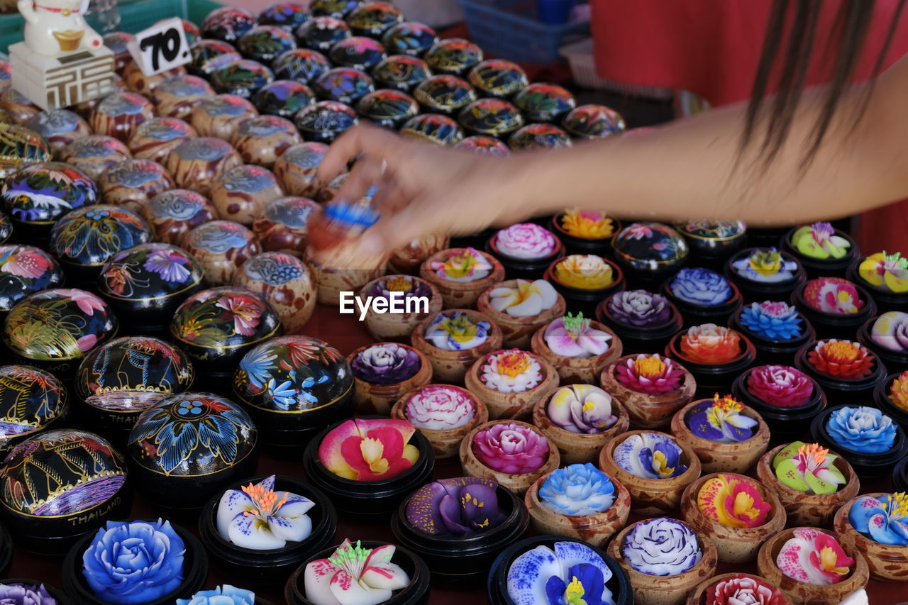 High angle view of human hand holding multi colored candies
