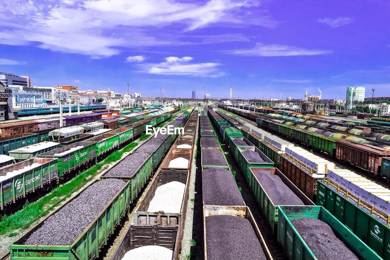 High angle view of freight trains at shunting yard against sky