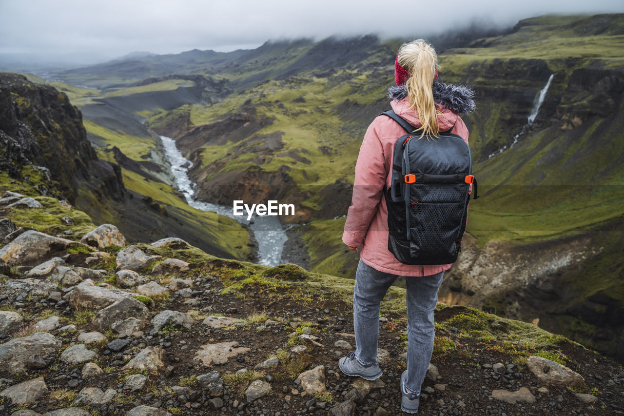 Close up of a woman with backpack enjoying icelandic, iceland
