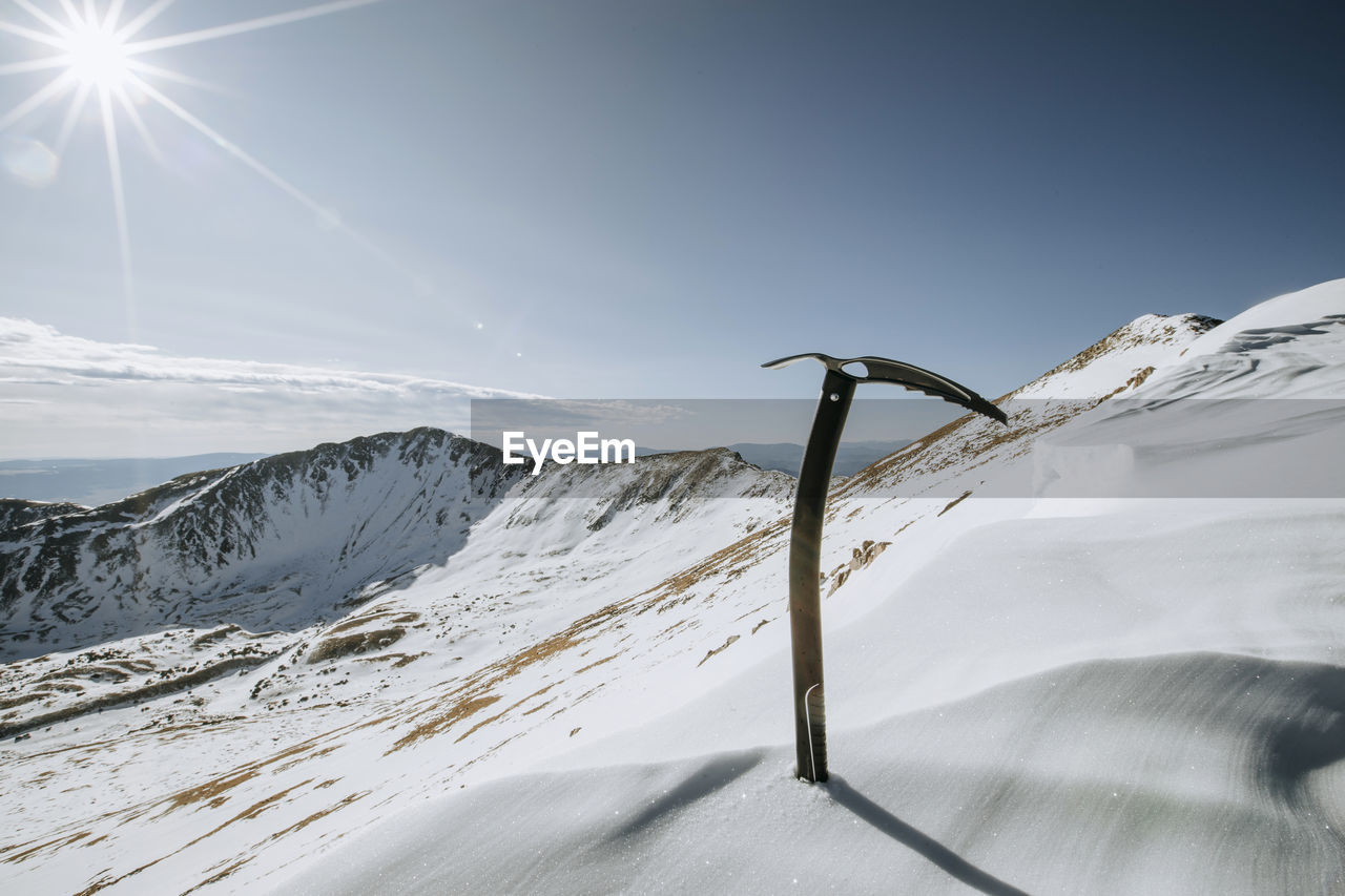 Mountaineering ice ax on snow slope near summit of wheeler peak, nm