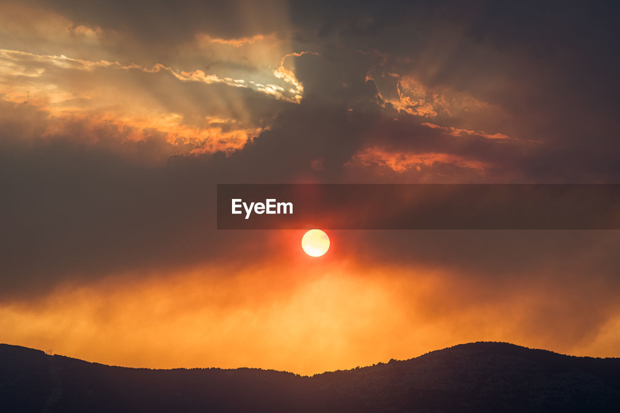 sky, beauty in nature, sunrise, cloud, mountain, sun, scenics - nature, dawn, nature, afterglow, environment, no people, silhouette, tranquility, dramatic sky, horizon, orange color, sunlight, landscape, morning, outdoors, astronomical object, tranquil scene, mountain range, moon, land, idyllic, full moon