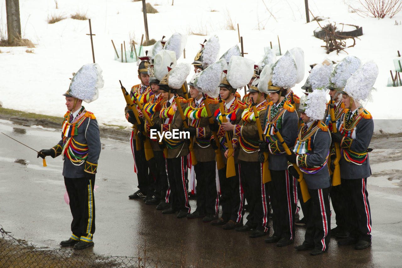 PANORAMIC VIEW OF PEOPLE STANDING IN TRADITIONAL CLOTHING