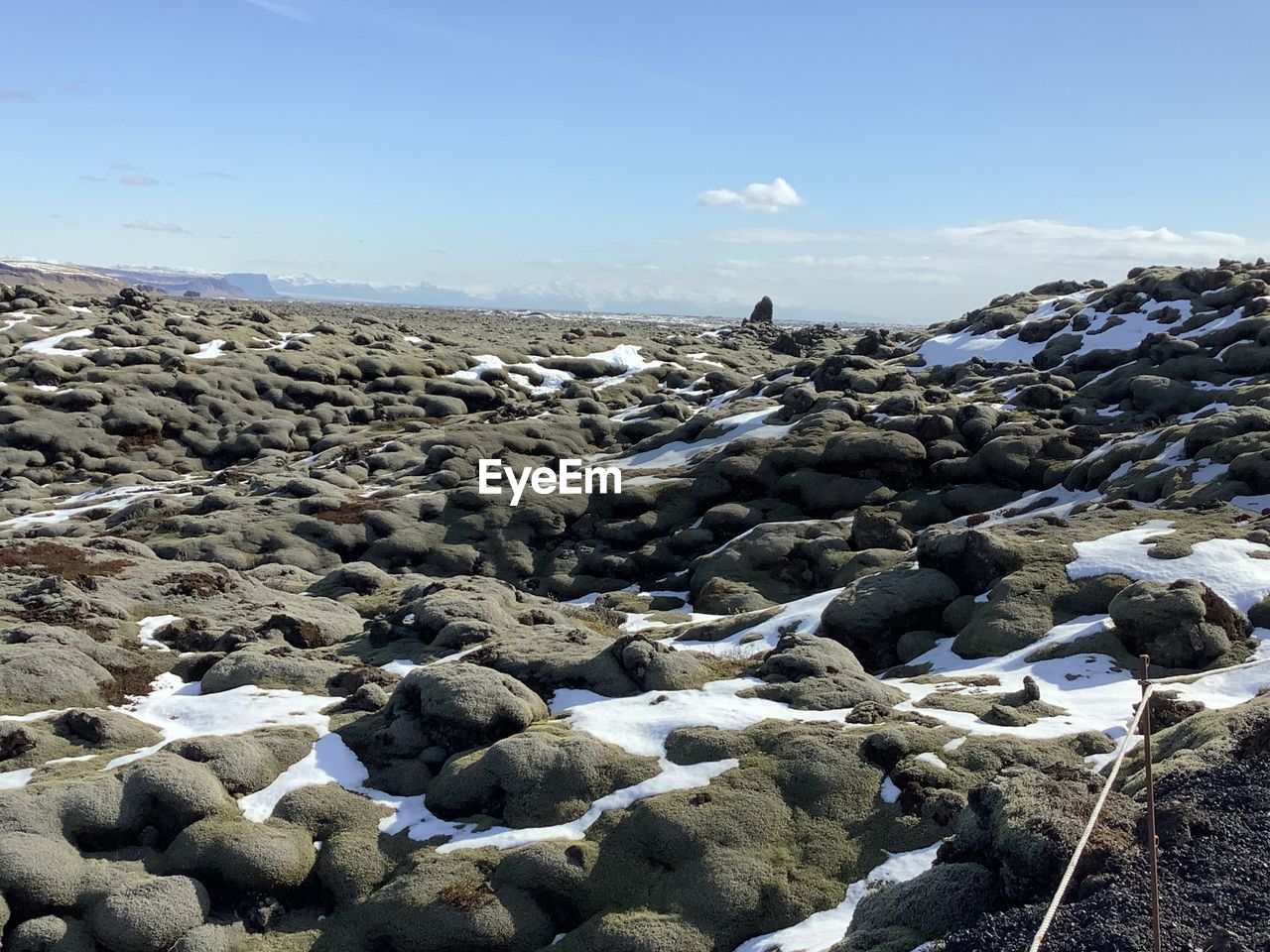 Landscape of lava fields as far as the eye can see covered by moss and snow