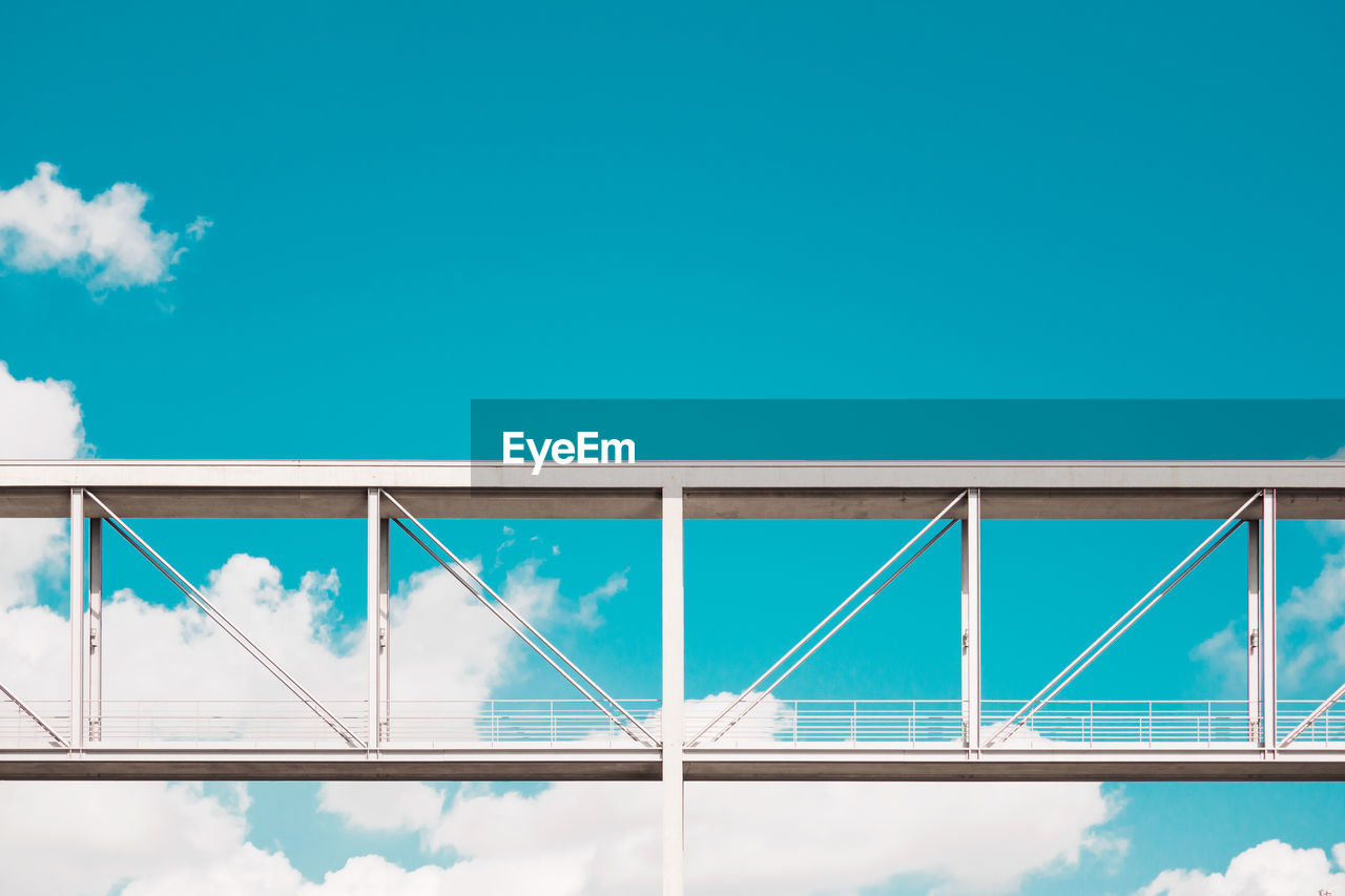 Low angle view of bridge against blue sky