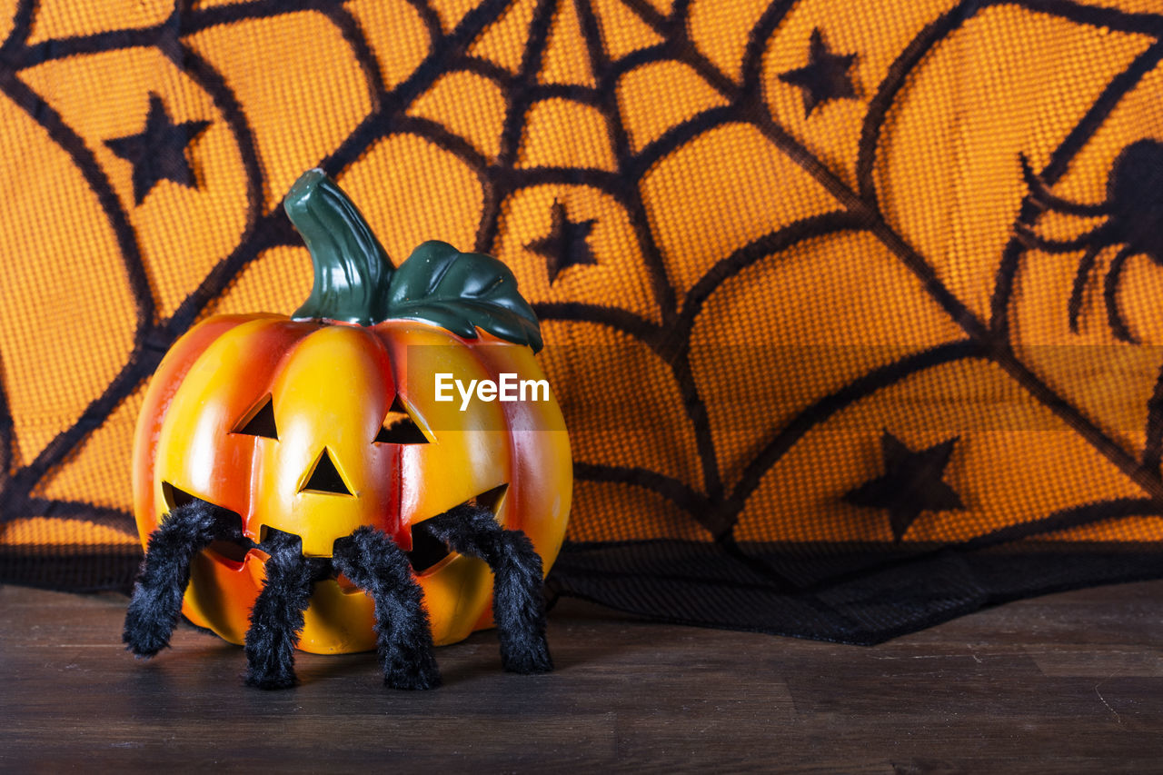 Jack o lantern on wooden table during halloween