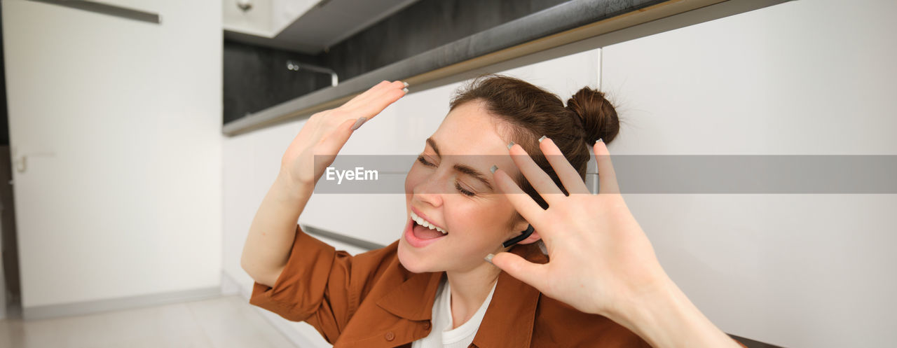 portrait of young woman looking through window