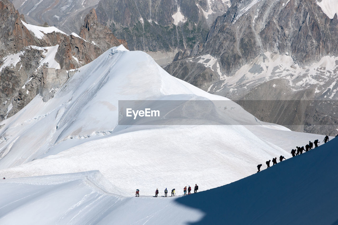 Aerial view of people on snow covered mountain