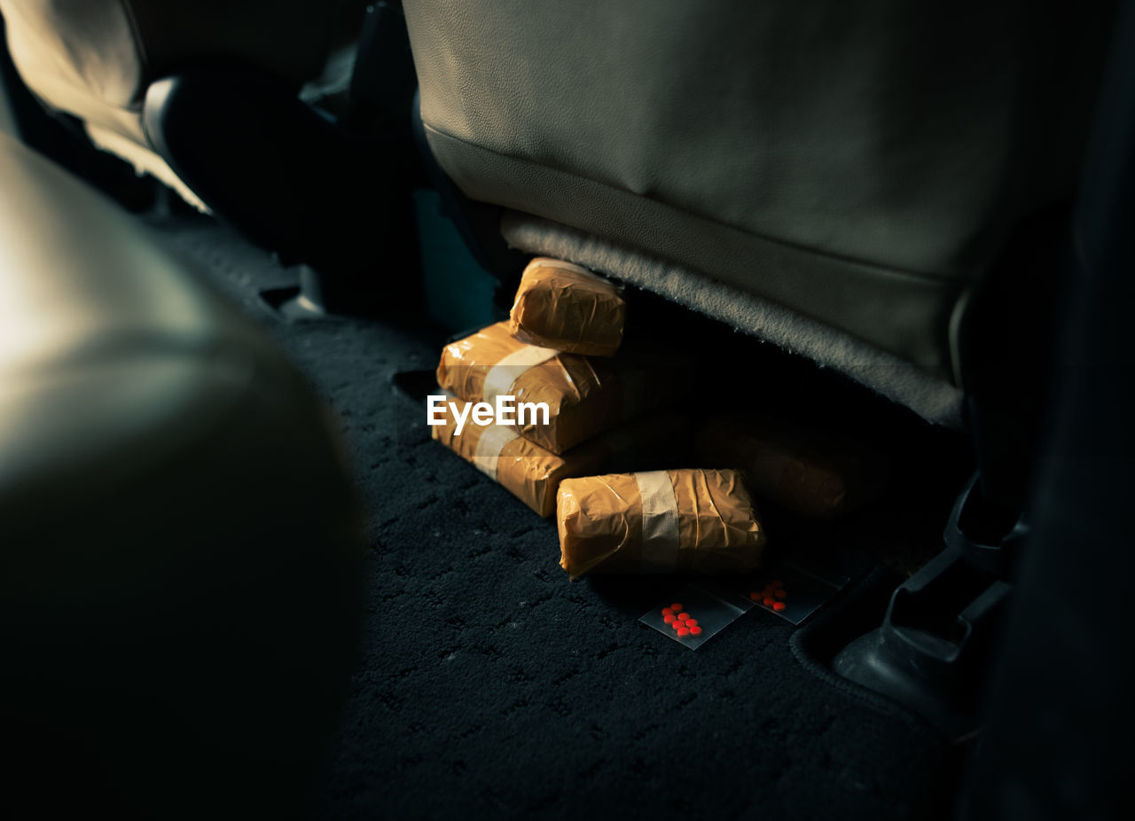 HIGH ANGLE VIEW OF SHOES BY CAR