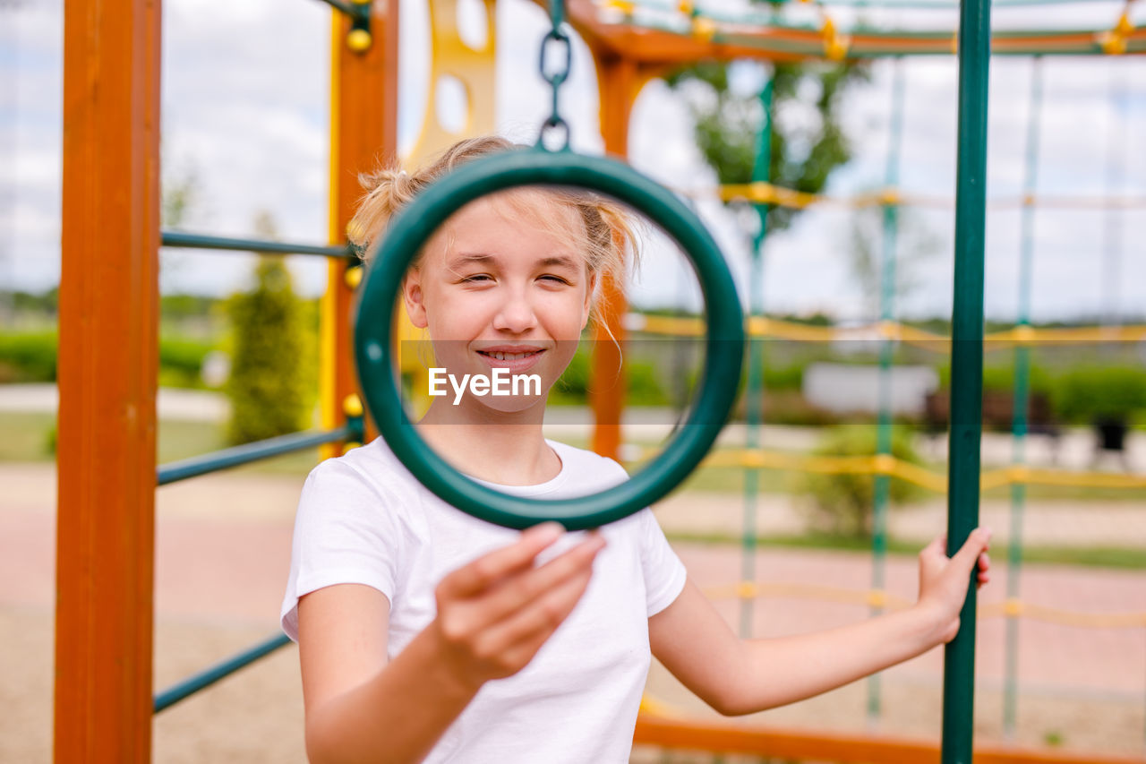 Portrait of boy standing in park