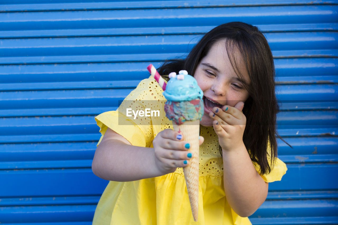 Teenager girl with down syndrome enjoying an ice cream