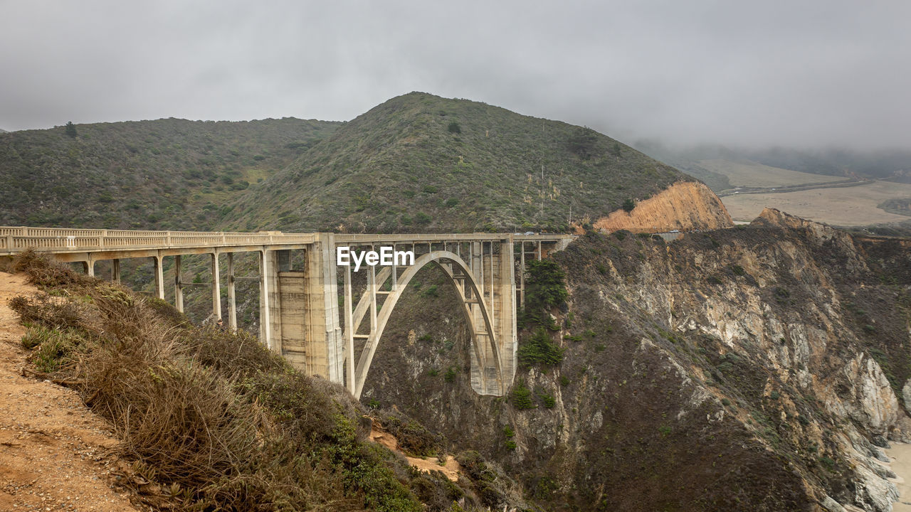 The bixby bridge in the big sur coastal area in the us state of california on a cloudy foggy day.