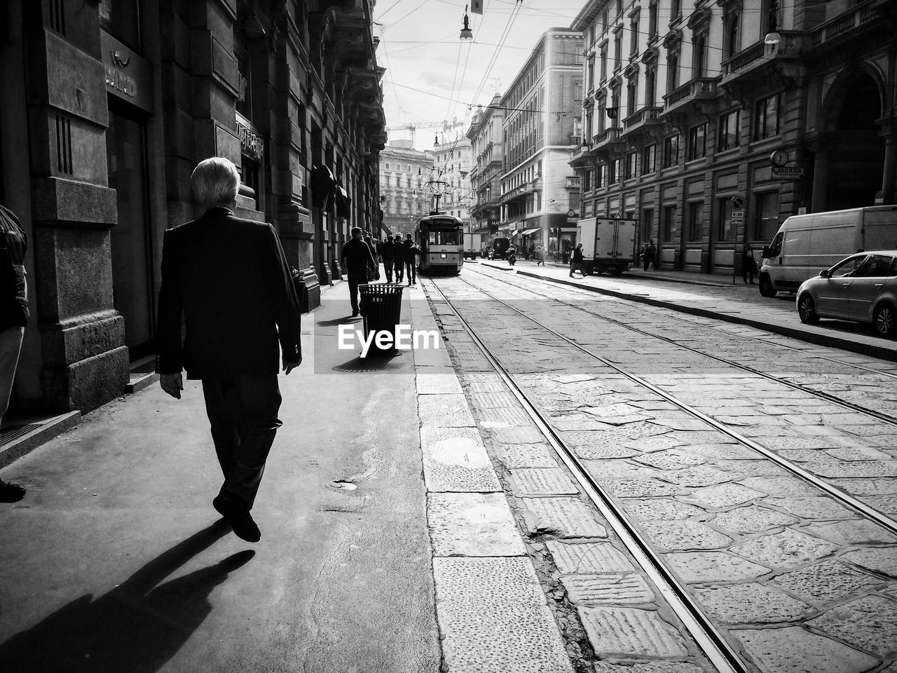 PEOPLE WALKING ON STREET IN CITY