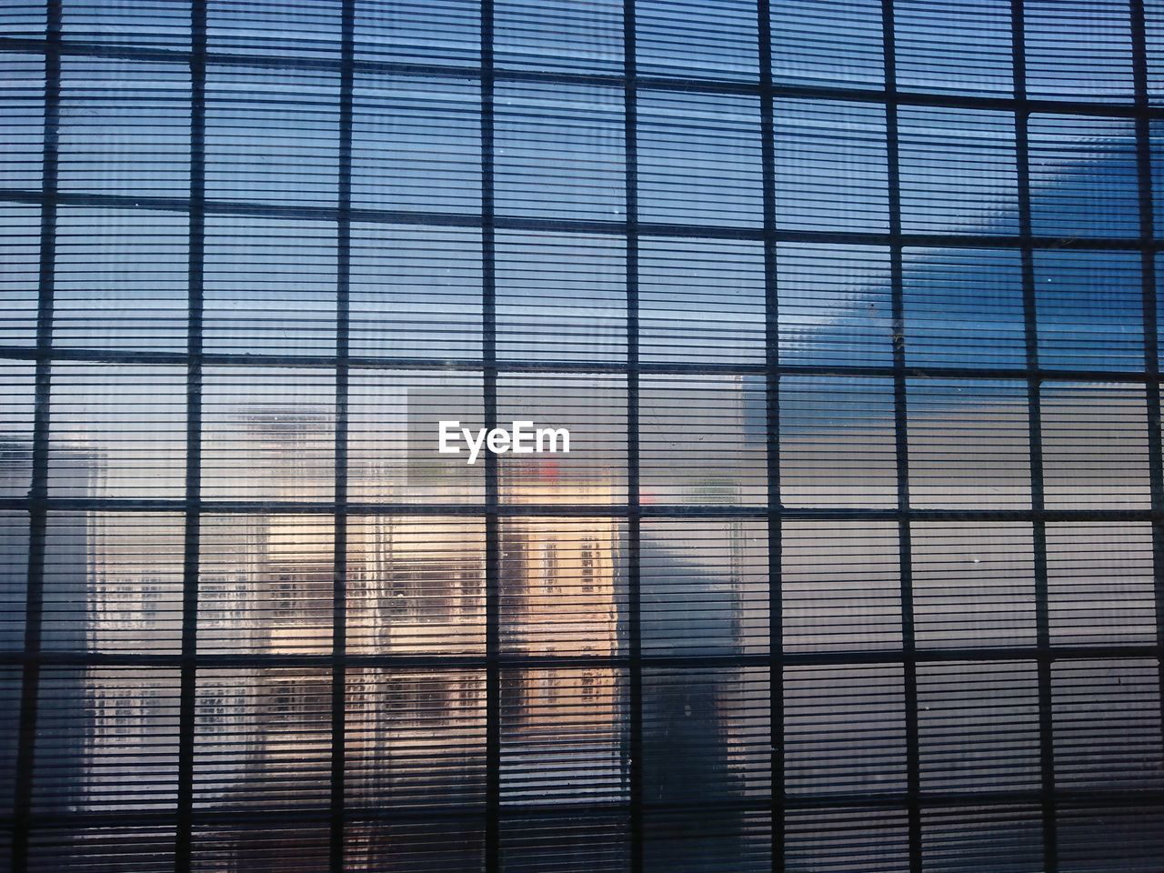FULL FRAME SHOT OF GLASS WINDOW WITH BUILDING IN BACKGROUND