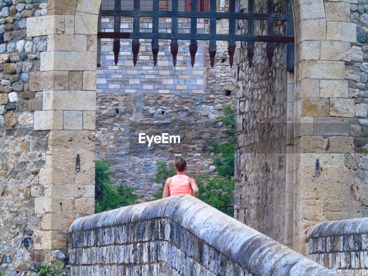 Rear view of woman standing at castle entrance