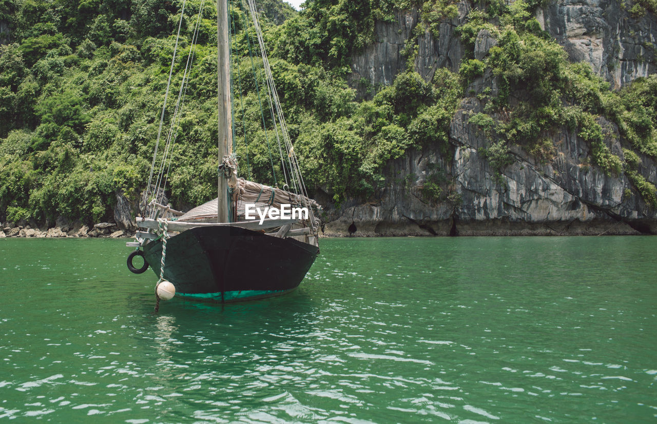 Nautical vessel on halong bay by mountain