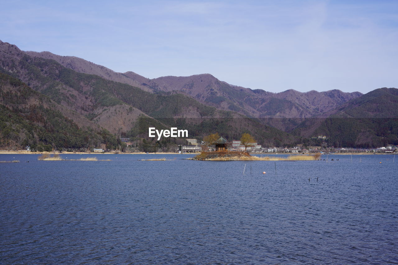 SCENIC VIEW OF SEA BY MOUNTAIN AGAINST SKY