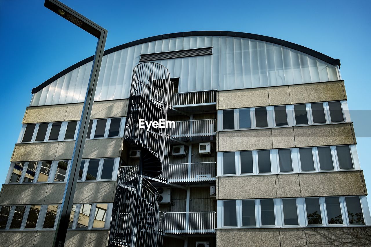 Low angle view of building against clear blue sky