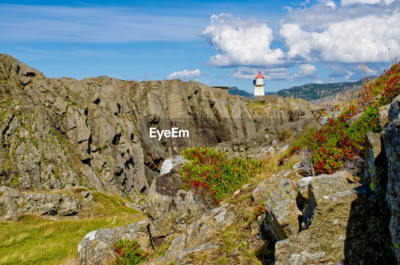 Varnes fyr lighthouse peeps out of the rocky terrain 