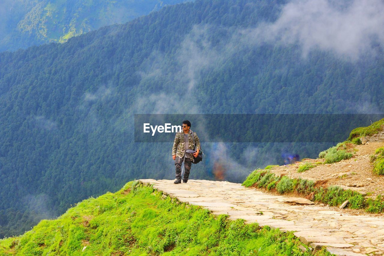 Rear view of man standing on mountain