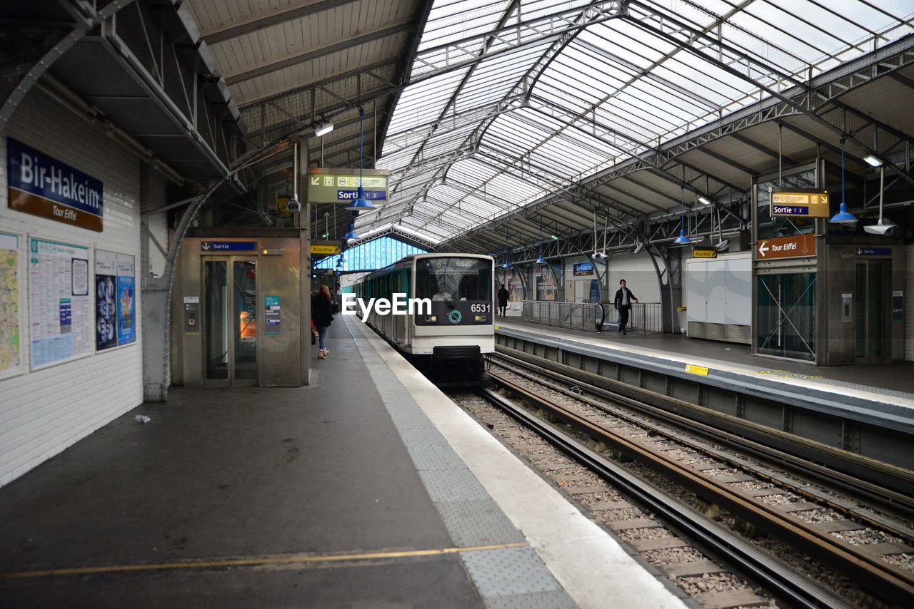 TRAIN ON RAILROAD STATION PLATFORM